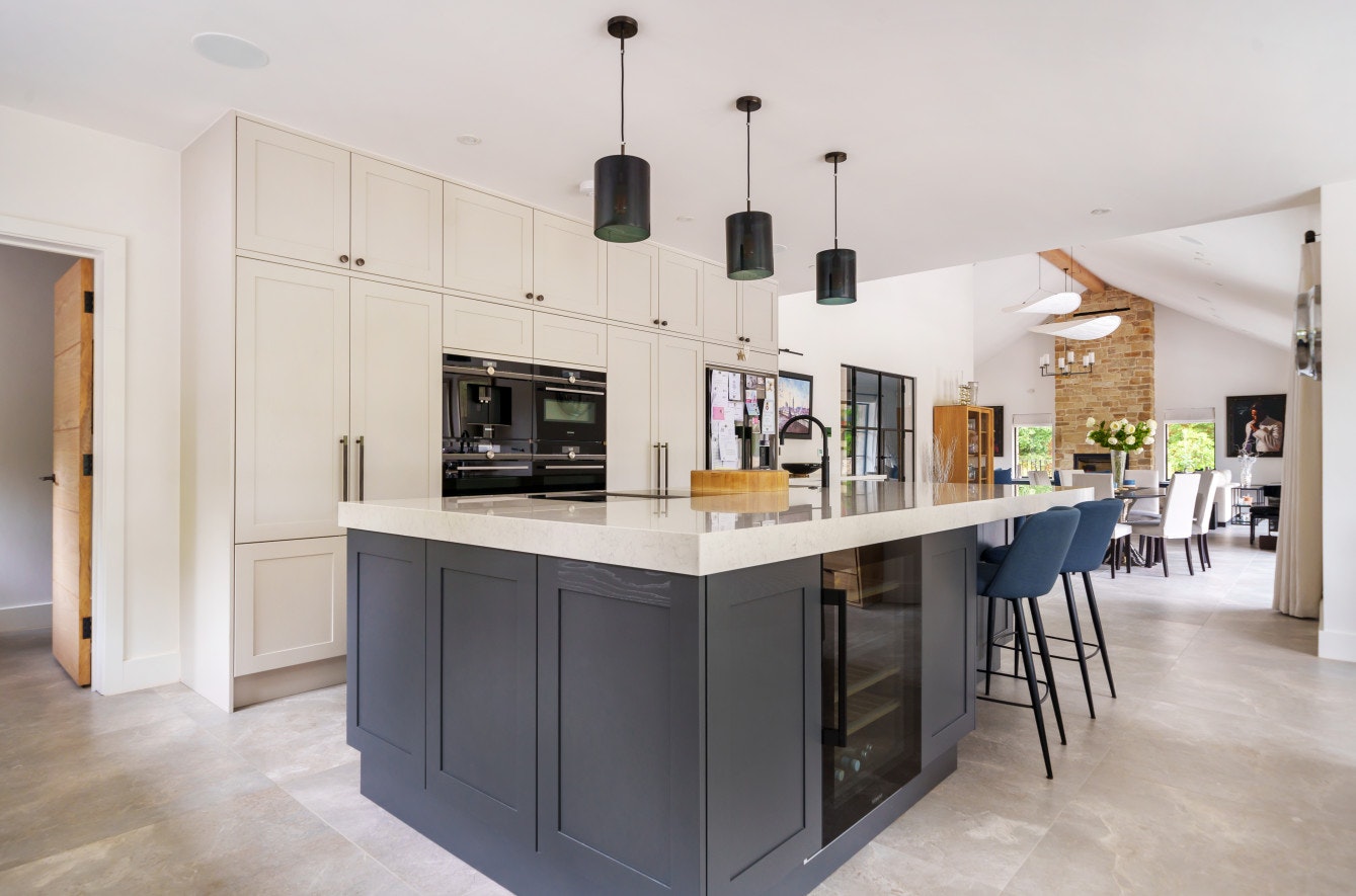 A key feature of the generous open-plan space is a large island that incorporates storage, a seating area, a wine fridge, hob, Quooker tap and prep sink
